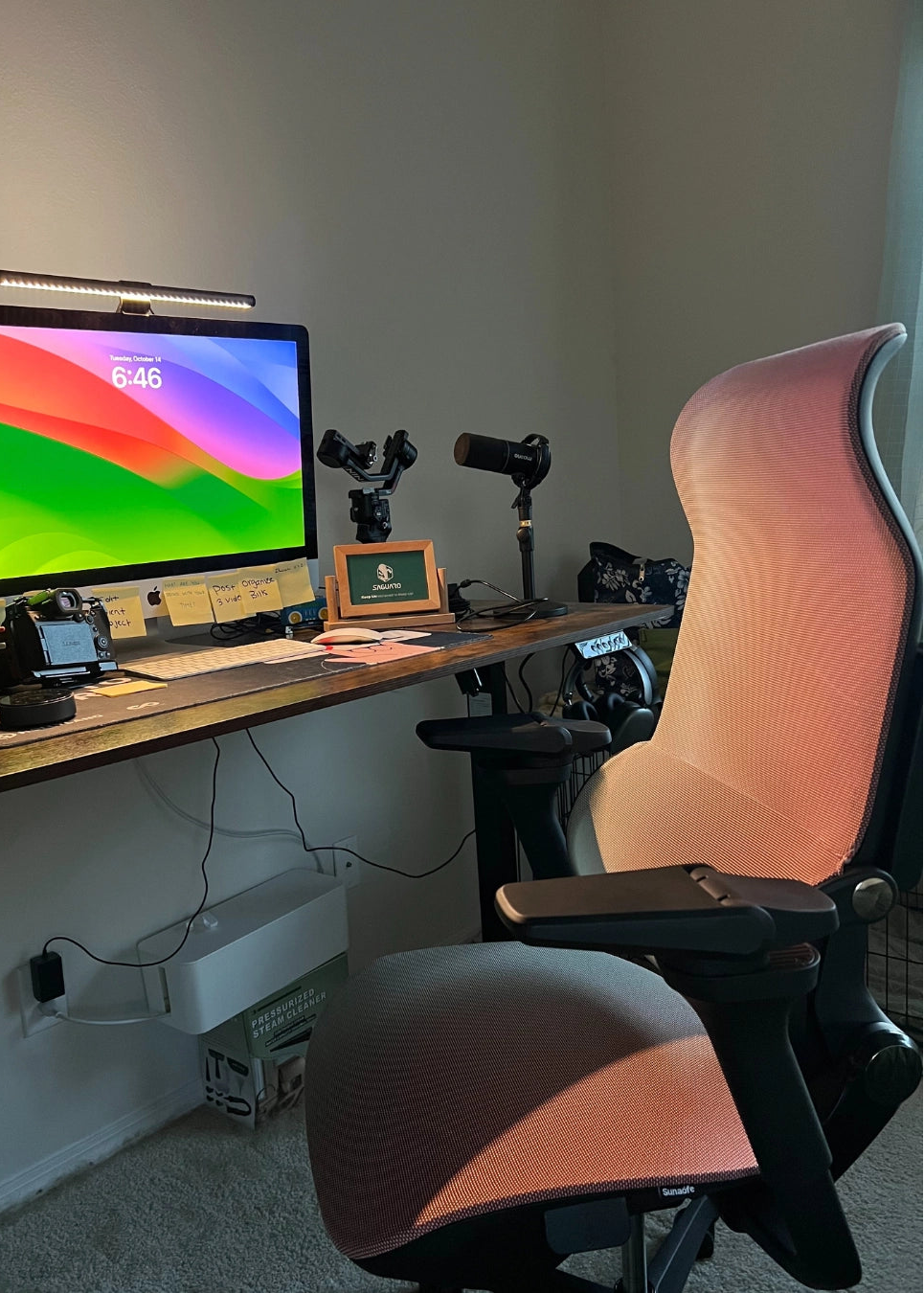 A Sunaofe ergonomic mesh office chair paired with a wooden desk in a professional home office setup.