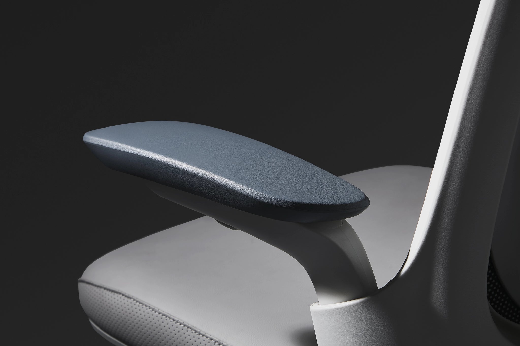 Close-up of a Sunaofe ergonomic office chair featuring a sleek blue padded armrest and premium white frame.