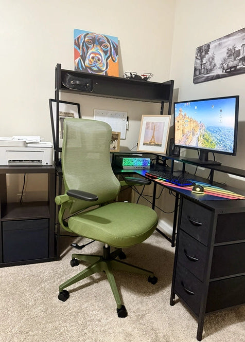 A Sunaofe green ergonomic office chair paired with a black L-shaped desk in a cozy home office.