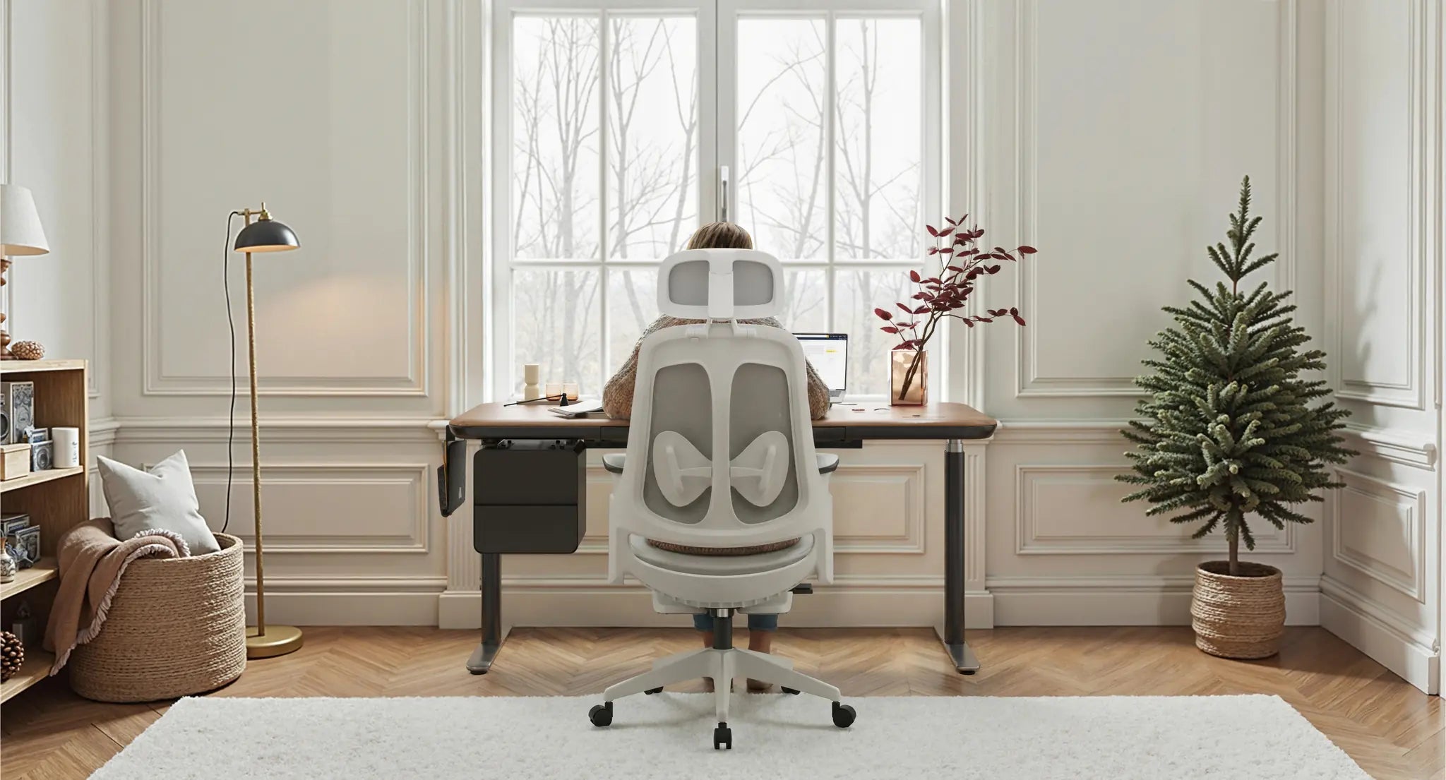 Person working at a Sunaofe height adjustable desk with ergonomic chair in a bright, modern office.