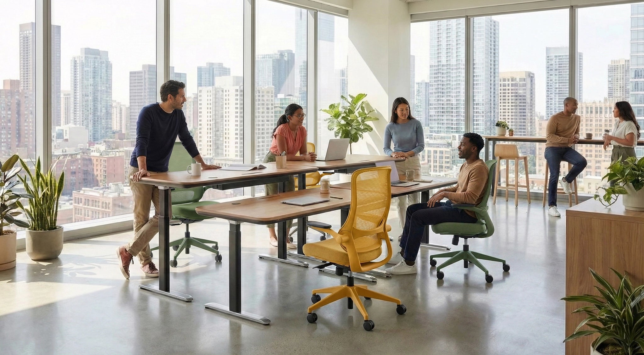 Professionals collaborating in a sunlit office using Sunaofe height-adjustable desks and ergonomic mesh chairs.