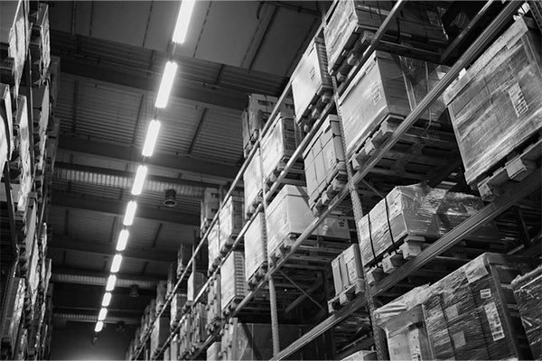 Sunaofe industrial warehouse facility featuring high shelving units and organized storage for office furniture products.